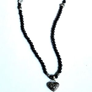 Black beaded mid length necklace with some marble print. Sliver hearts